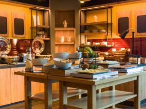 a kitchen with a table with bowls and plates on it at B&B HOTEL Inverness in Inverness