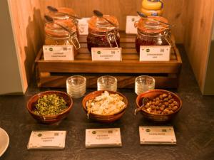 a table with bowls of food and jars of food at B&B HOTEL Inverness in Inverness +18 photos