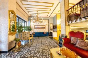 a lobby with couches and a chandelier at Diamond Royal Hotel in Istanbul