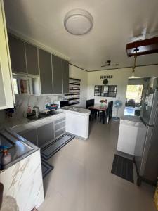 a kitchen with green cabinets and a table in it at Lemery farmbeach Escape in Lemery