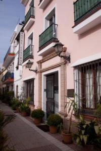 a large white building with a large window at Hotel Central Boutique in Marbella