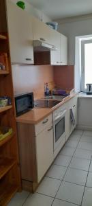 a kitchen with a sink and a stove at Ela Gar 6 WG Zimmer in Garsten +4 photos
