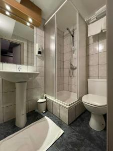 a bathroom with a sink and a toilet and a shower at Hotel Les Arcades - La-Roche-en-Ardenne in La-Roche-en-Ardenne +30 photos