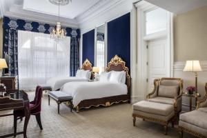 a bedroom with two beds and a chandelier at Waldorf Astoria Washington DC in Washington, D.C. +112 photos