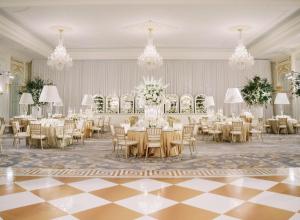 a banquet hall with tables and chairs and chandeliers at Waldorf Astoria Washington DC in Washington, D.C.