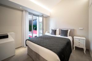 a bedroom with a large bed and a window at MyBlueVista LUXURY SEA VIEW PRIVATE VILLA CAP D AIL 200M MONACO in Cap d'Ail +15 photos