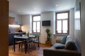 a living room with a couch and a table at Casa vacanza Garcia in Paluzza