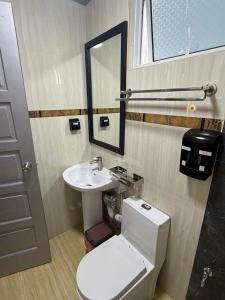a bathroom with a sink and a toilet and a mirror at HS Miracle View in Hulhumale +38 photos