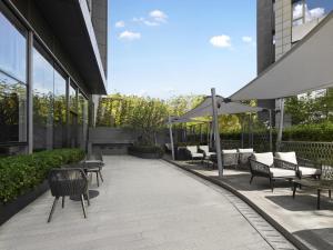 a patio with chairs and tables in a building at Hilton Zhuhai in Zhuhai