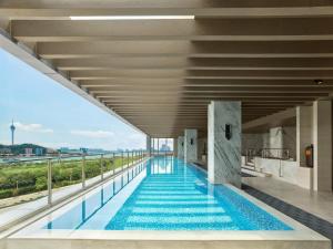 a swimming pool on the roof of a building at Hilton Zhuhai in Zhuhai