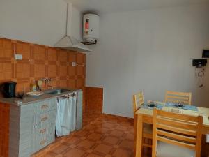 a kitchen with a sink and a counter with a table at Cactus del Valle 2 in Tinogasta