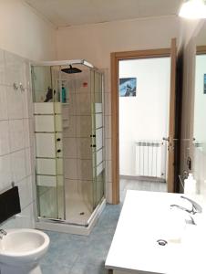 a bathroom with a shower and a toilet and a sink at Piccola Luna in Menaggio +31 photos