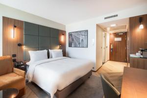 a hotel room with a large bed and a desk at Radisson Blu Hotel, Montpellier in Montpellier