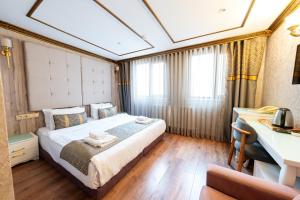 a bedroom with a large bed and a desk at Diamond Royal Hotel in Istanbul +79 photos