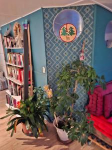 a living room with potted plants and a book shelf at Bateau Escapade in Ramonville-Saint-Agne +3 photos