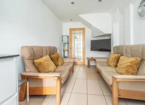 a living room with a couch and a tv at Soofi House in Sheffield