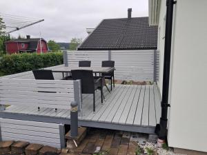 a wooden deck with a table and chairs on it at Guest house Norrköping in Norrköping