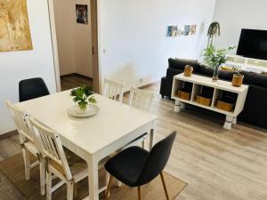 a living room with a white table and chairs at Rocha Atlantico in Portimão +8 photos