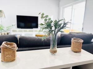 a vase of flowers on a table in a living room at Rocha Atlantico in Portimão
