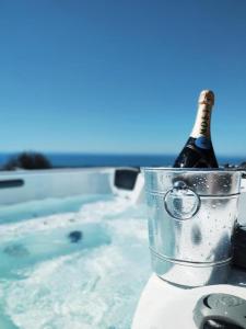 a bottle of champagne in a bucket on a table at Le Dimore di Mariuccia 1 in Monte SantʼAngelo
