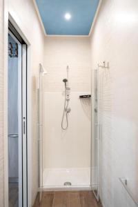 a bathroom with a shower with a glass door at Le Dimore di Mariuccia 1 in Monte SantʼAngelo