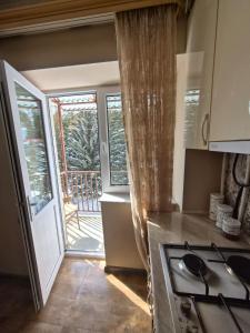 a kitchen with a stove top oven next to a balcony at Apartment in Jermuk in Jermuk +10 photos