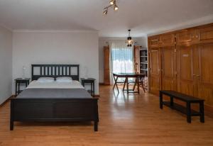 a bedroom with a bed and a table in it at Galo Preto - Sintra Guesthouse in Sintra
