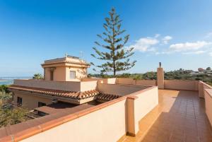 a view from the balcony of a house with a tree at Comeback Villa Itaca in Motril