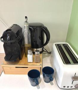 a kitchen counter with a coffee pot and a toaster at Sleep and Go Lyon Oullins in Oullins