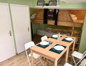 a table and chairs in a room with a bunk bed at Sleep and Go Lyon Oullins in Oullins +2 photos