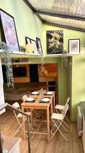 a dining room with a wooden table and chairs at Sleep and Go Lyon Oullins in Oullins