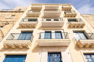 a building with balconies on the side of it at V86 - Charming 1 Bedroom Isla Duplex Apt with Harbour Views in Senglea