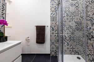 a bathroom with a shower with a glass door at V86 - Charming 1 Bedroom Isla Duplex Apt with Harbour Views in Senglea +20 photos