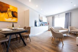 a kitchen and dining room with a table and chairs at V86 - Charming 1 Bedroom Isla Duplex Apt with Harbour Views in Senglea