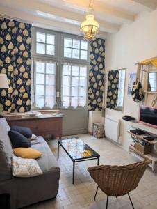 a living room with a couch and a table at La Chancellerie in Loches