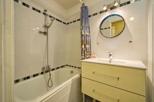 a bathroom with a sink and a tub and a shower at La Chancellerie in Loches