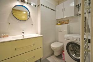 a bathroom with a sink and a washing machine at La Chancellerie in Loches