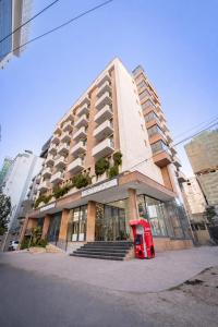 a red bus parked in front of a building at Liyu Hotel Apartment in Addis Ababa