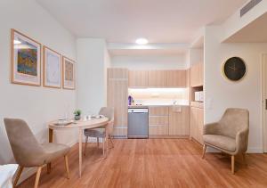 a kitchen with a table and chairs in a room at Zenao Appart'hôtels Saint-Mandé in Saint-Mandé