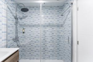 a shower with a glass door in a bathroom at A unique experience in Porto in Porto +27 photos