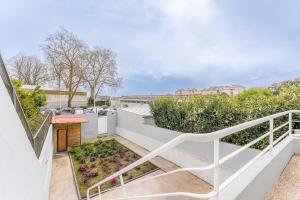 an apartment with a balcony with a garden at A unique experience in Porto in Porto