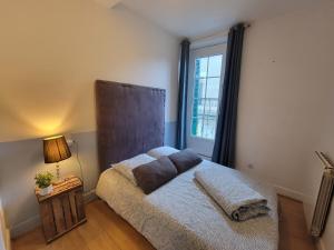 a bedroom with a bed with a large window at Chambre Lumineuse avec Balcon - Cuisine Partagée & Salle de Bain Privée in Lourdes