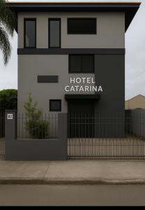 a building with a hotel captainma sign on it at Pousada Catarina in Biguaçu