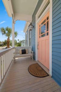 a porch with a bench on a house at Rustic Luxury - As Seen on "Restoring Galveston" TV Show in Galveston