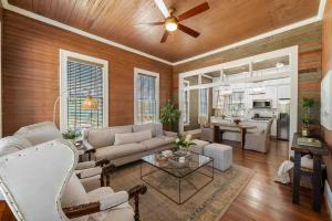 a living room with a couch and a ceiling fan at Rustic Luxury - As Seen on "Restoring Galveston" TV Show in Galveston