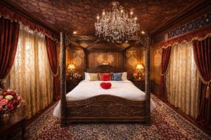 a bedroom with a canopy bed with a red heart on it at Chicago Group of Houseboats in Srinagar +75 photos