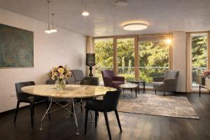 a living room with a table and chairs at Grand Apartment Sissi in Trieste +49 photos