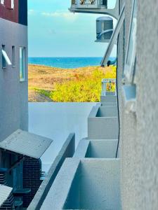 a view of the ocean from a balcony of a building at Diamante dos Ventos Duplex com Piscina Cumbuco in Caucaia