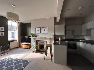 a kitchen with a stove and a fireplace at The Linen Loft - 2 Bed Apartment - Central Town Location - Reserved Parking Space Included in Ross on Wye