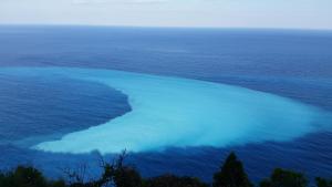 an island in the ocean with blue water at Okeanos Vine Luxury Villa in Athani +44 photos